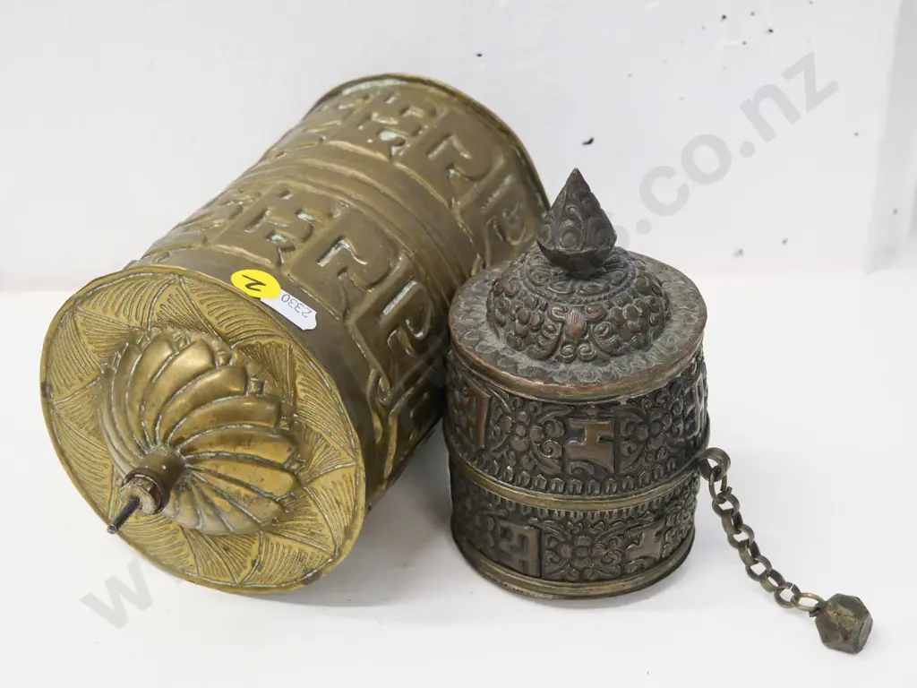 2 pressed metal prayer wheels - one brass with wood & metal spindle, L-230, smaller has weight on chain, top comes off Image 1++