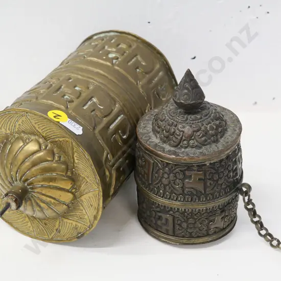 2 pressed metal prayer wheels - one brass with wood & metal spindle, L-230, smaller has weight on chain, top comes off