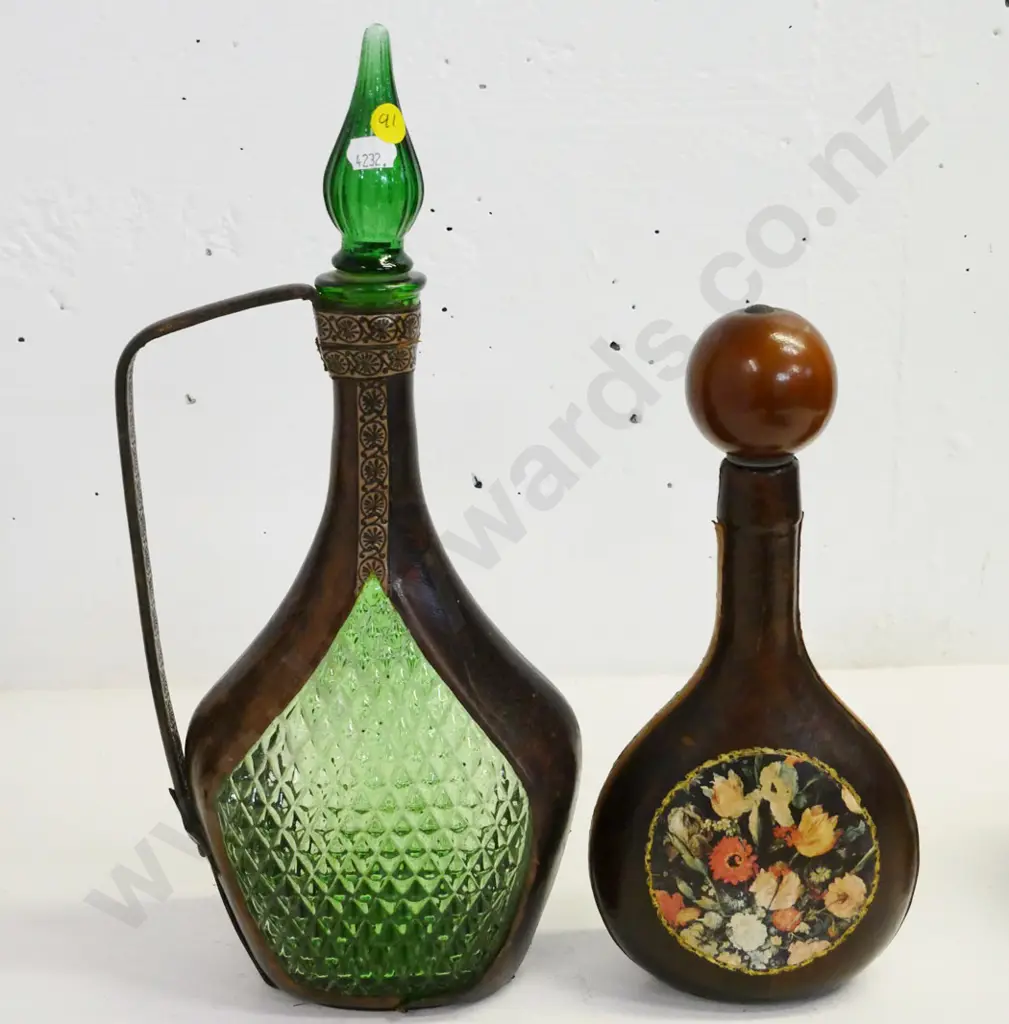 leather covered green glass items -  stoppered genie decanter H380 (some fraying to leather) and one with floral motif Image 1++