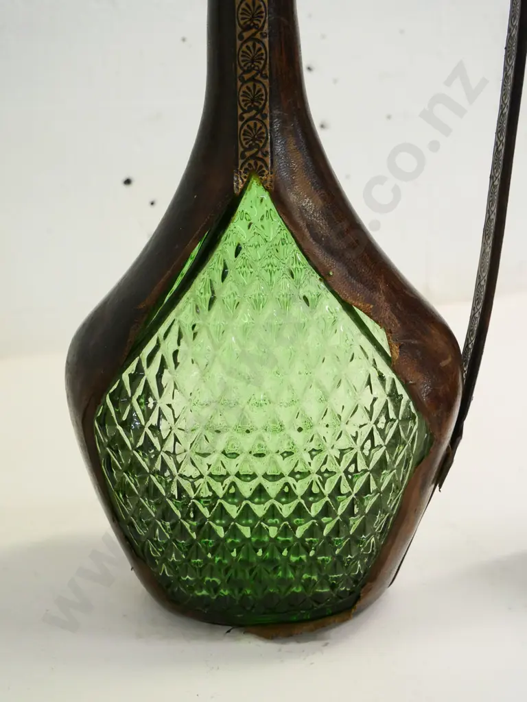 leather covered green glass items -  stoppered genie decanter H380 (some fraying to leather) and one with floral motif Image 1++