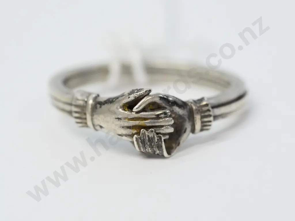 silver ring holding hands - no visible mark Image 1++