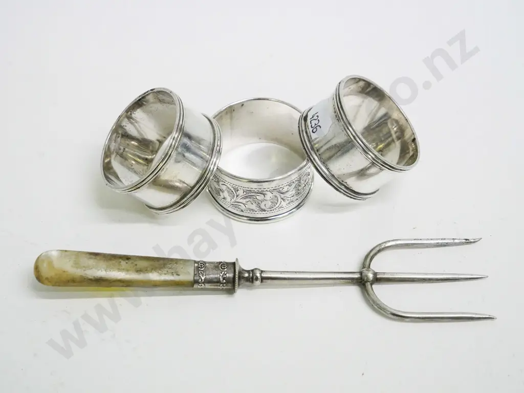 3 sterling silver napkin rings, one has etched pattern, and a serving fork with sterling mount & mother of pearl handle Image 1++