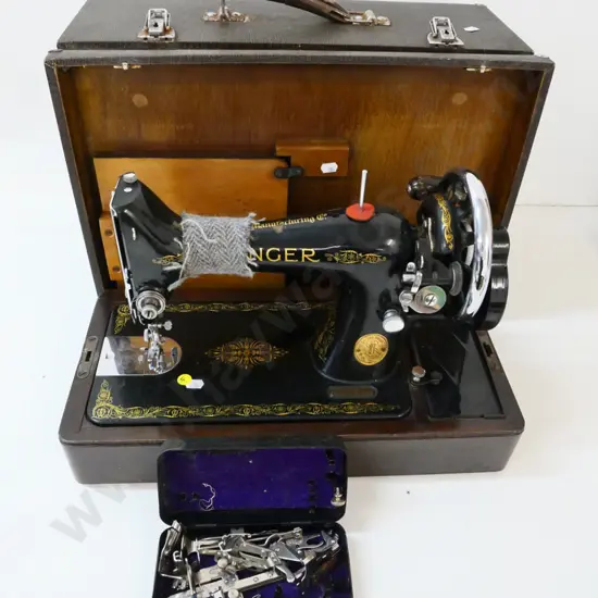vintage portable cased Singer sewing machine in working order, with tin of attachments, some wear to case