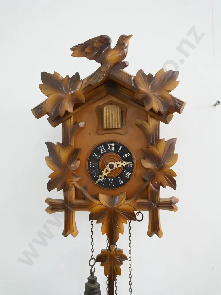 wood-cased cuckoo clock with 2 weights, lift-off top trim piece. Some numbering worn off. Case H-280 W-200 Image 1++