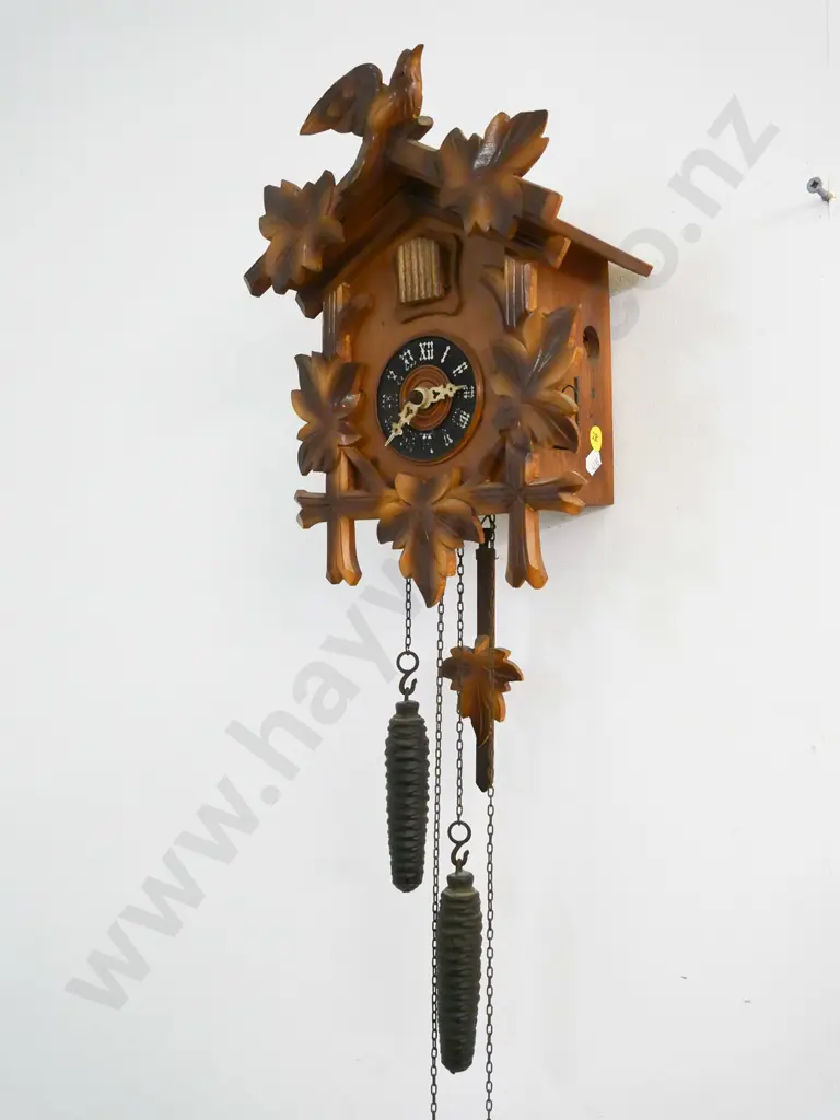 wood-cased cuckoo clock with 2 weights, lift-off top trim piece. Some numbering worn off. Case H-280 W-200 Image 1++