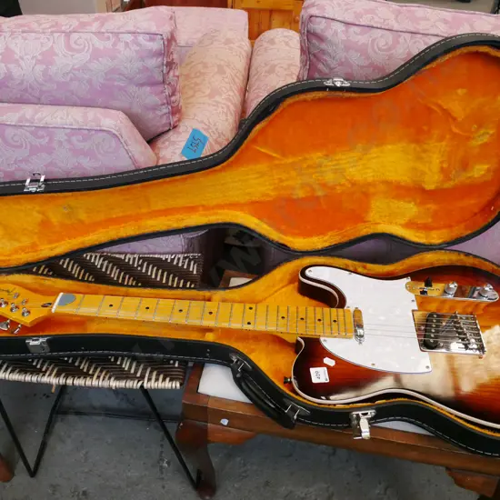 cased Fender Telecaster electric guitar