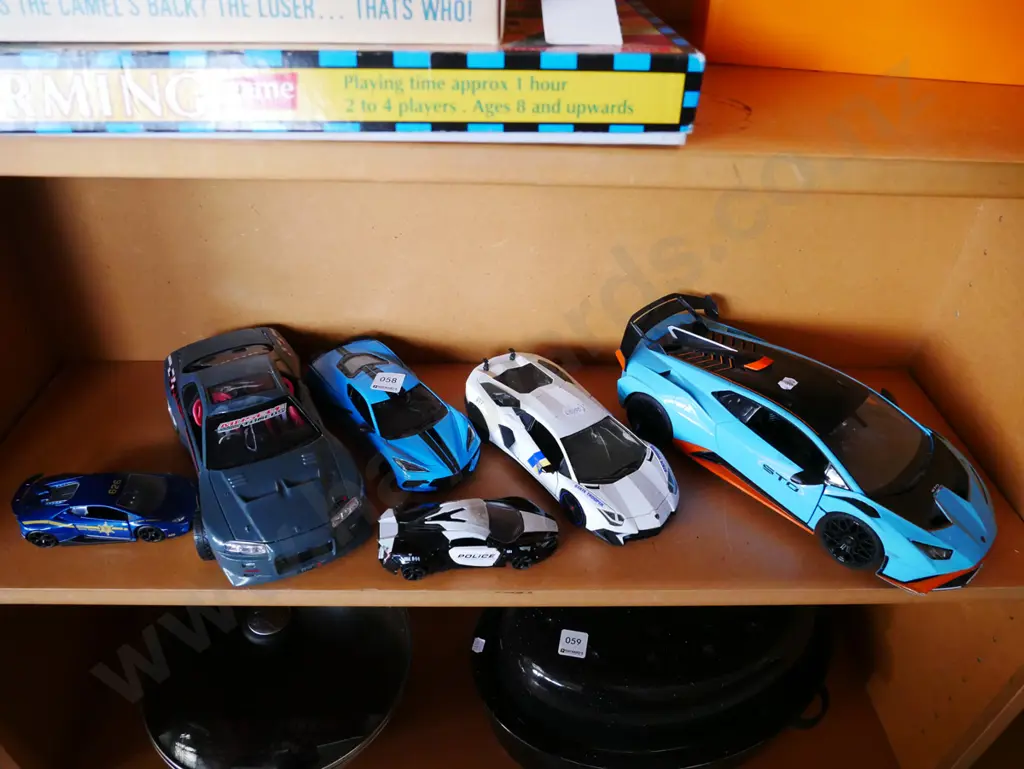 shelf of plastic and die cast model vehicles Image 1++