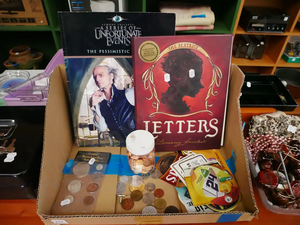 box; coins, beer labels, Lemony Snickett books Image 1++