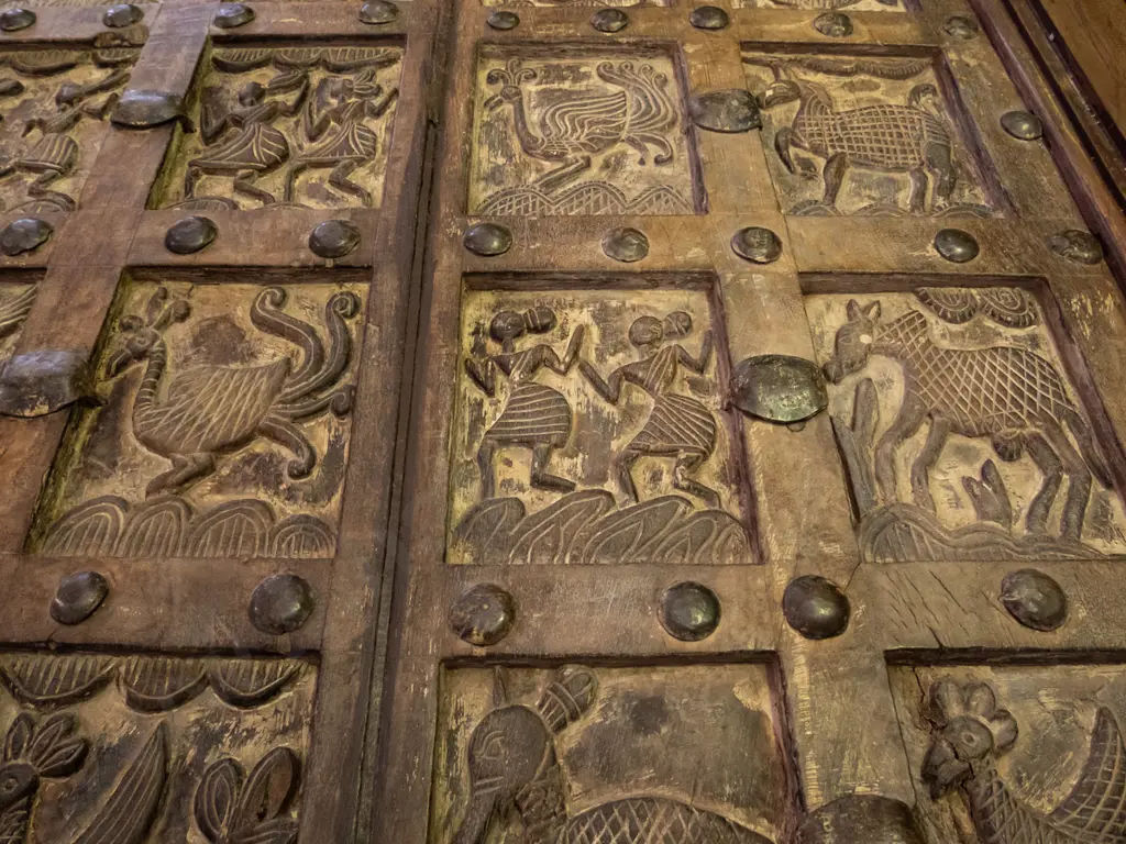  hardwood turned leg dining table with top made from 2 heavily carved temple doors and glass cover Image 1++