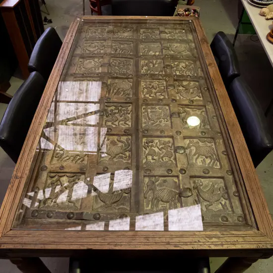  hardwood turned leg dining table with top made from 2 heavily carved temple doors and glass cover