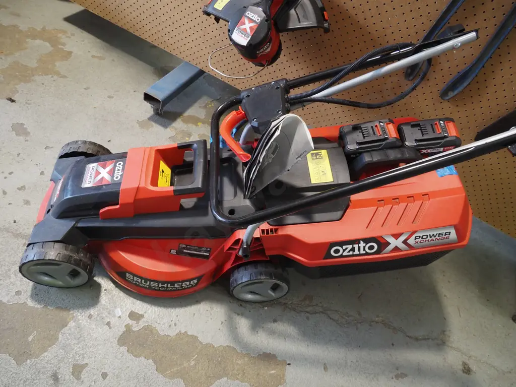 Ozito 18V line trimmer, lawn mower, charger, 2 batteries - batteries in office Image 1++