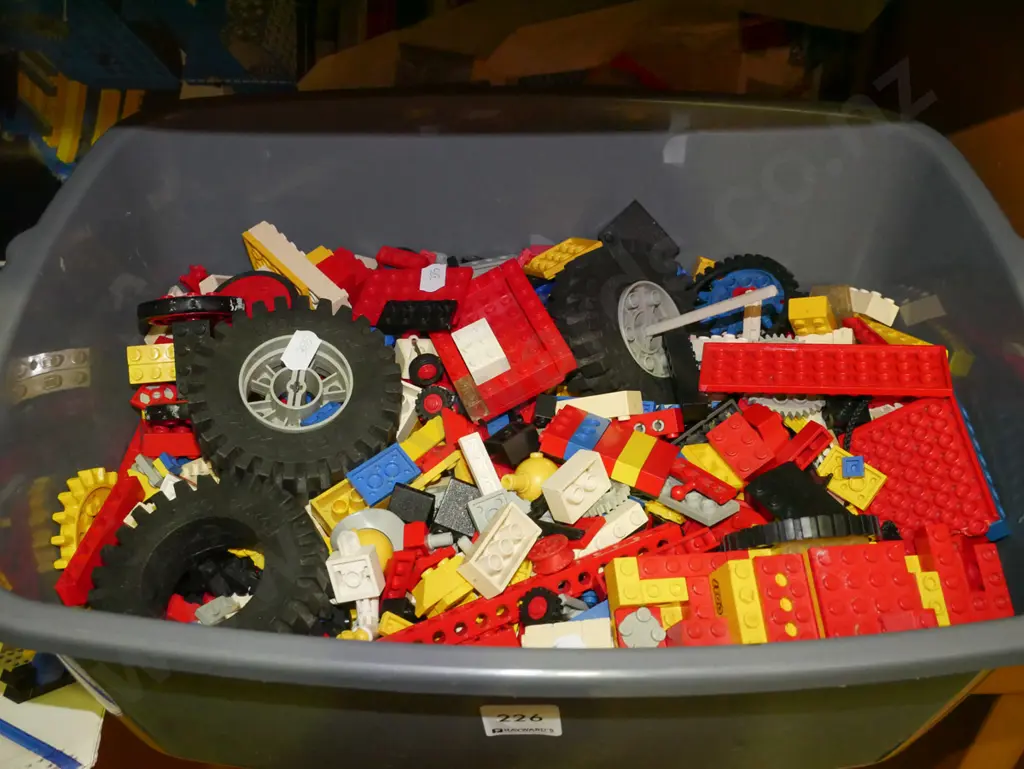 plastic tub of early Lego pieces and instruction books Image 1++