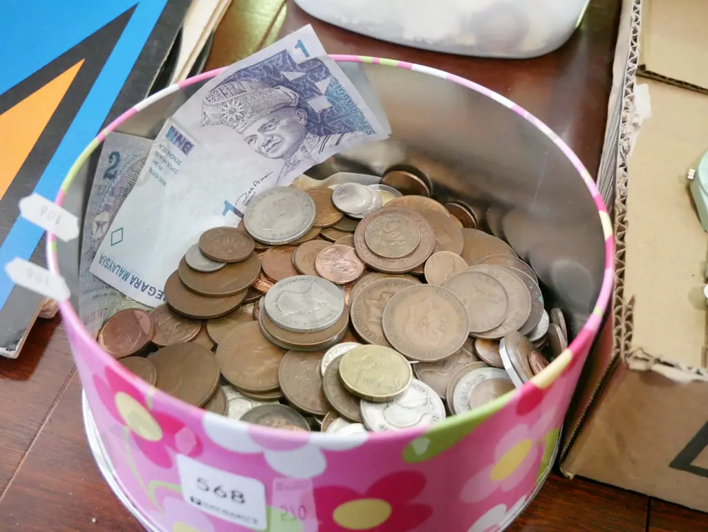 tin of coins and bank notes Image 1++