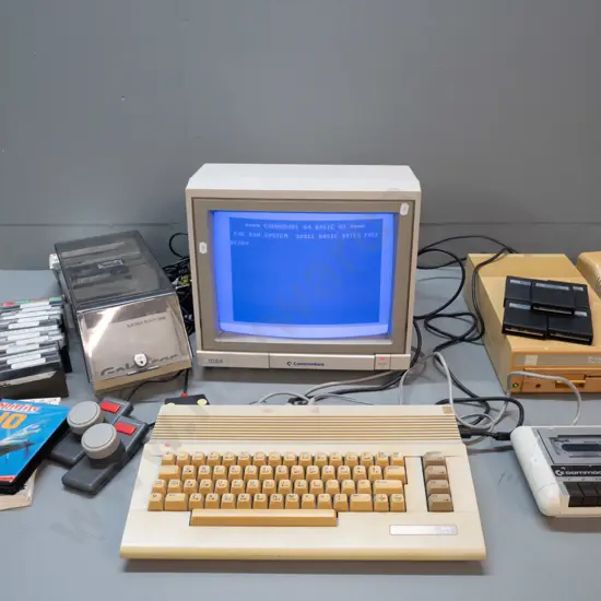 1980s Commodore 64 computer with CRT, tape drive, floppy drive, game cartridges, controllers, floppies etc - powers up,