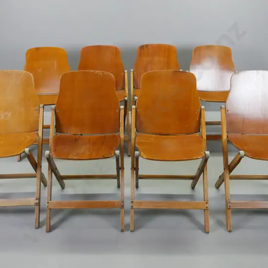 8 vintage folding chairs with rimu ply seats and backs, fluted legs, metal caps and mechanisms - some w/ original decal: