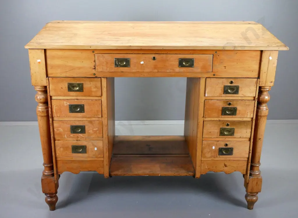 restorer's vintage rimu clerk's desk with sloped top, large top drawer, 8 lower drawers, brass campaign handles, turned Image 1++