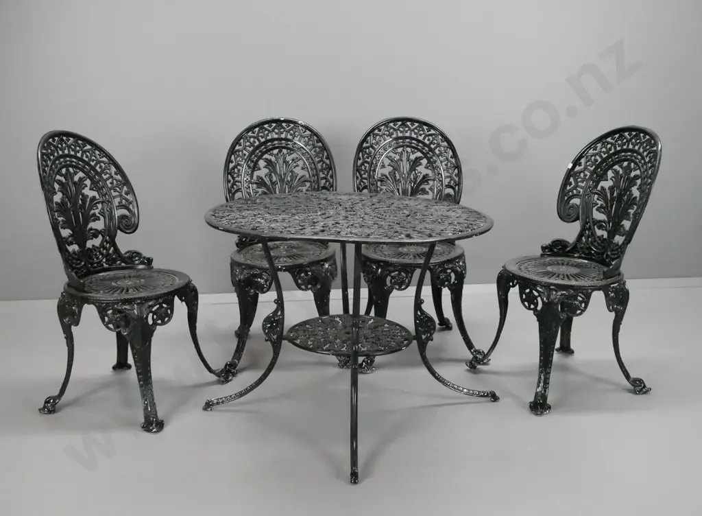 cast alloy black painted patio table and 4 chairs table has lower shelf and umbrella holes - warping to table top, needs Image 1++