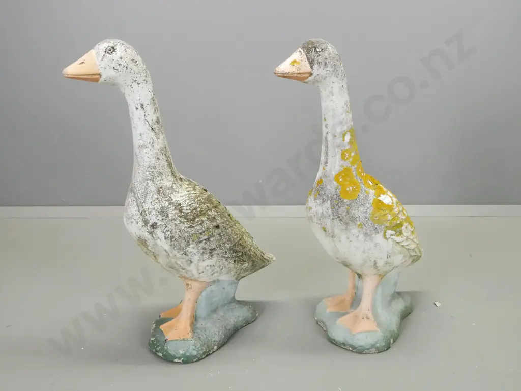 pair of concrete garden geese with painted details, overall lichen and patination, a few chips and a crack that may be a Image 1++