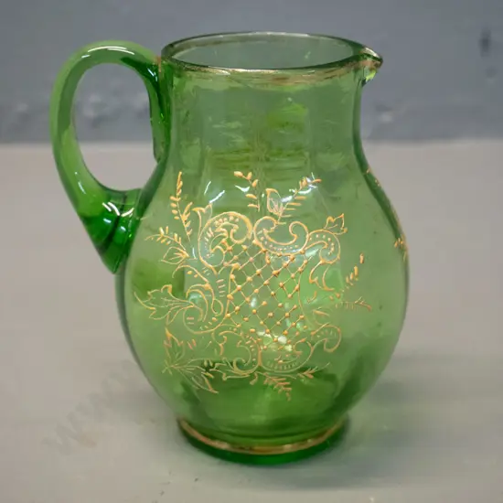 vintage green uranium glass jug with raised decoration, some wear to gilt on rim H-110