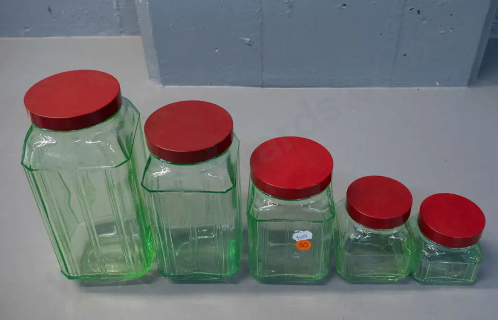 vintage graduated set of 5 green uranium glass storage jars with red bakelite lids - tallest is H-200 Image 1++
