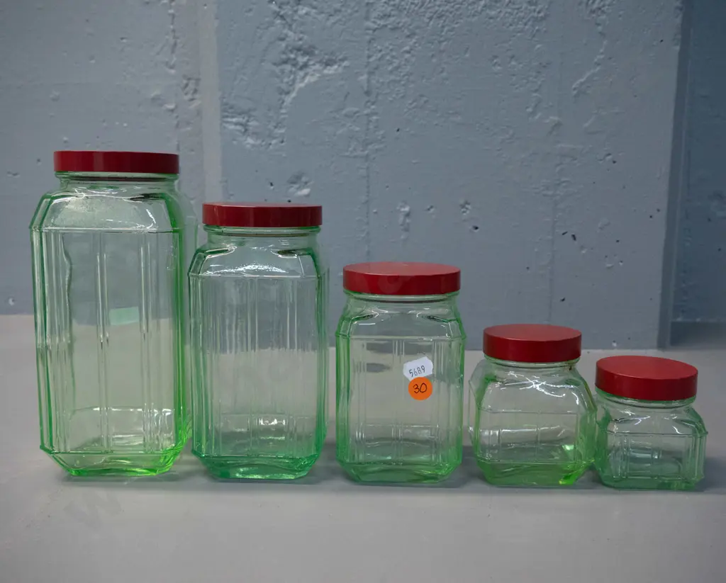 vintage graduated set of 5 green uranium glass storage jars with red bakelite lids - tallest is H-200 Image 1++