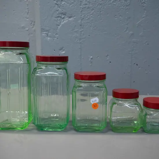 vintage graduated set of 5 green uranium glass storage jars with red bakelite lids - tallest is H-200