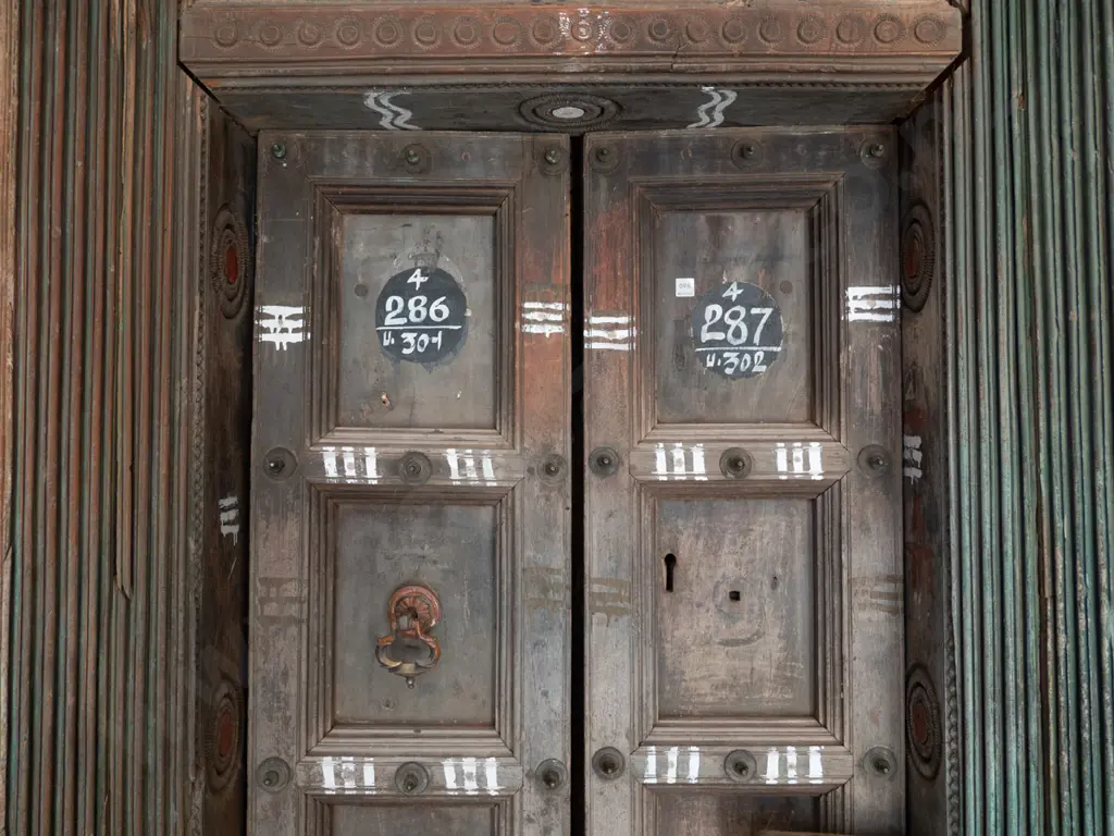 heavy Indian Madurai carved hardwood entrance door - 2 doors, cast metal drop handle, metal studding Image 1++