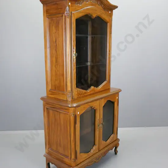 reproduction oak and elm display cabinet with single top and 2 lower glazed shaped cupboard doors, mirrored back on top,