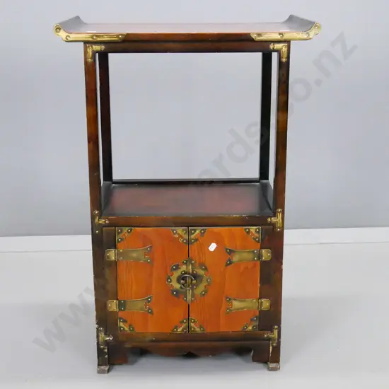 asian scroll top end table with lower 2-door cupboard lined with paper, brass strapping to doors and corners,