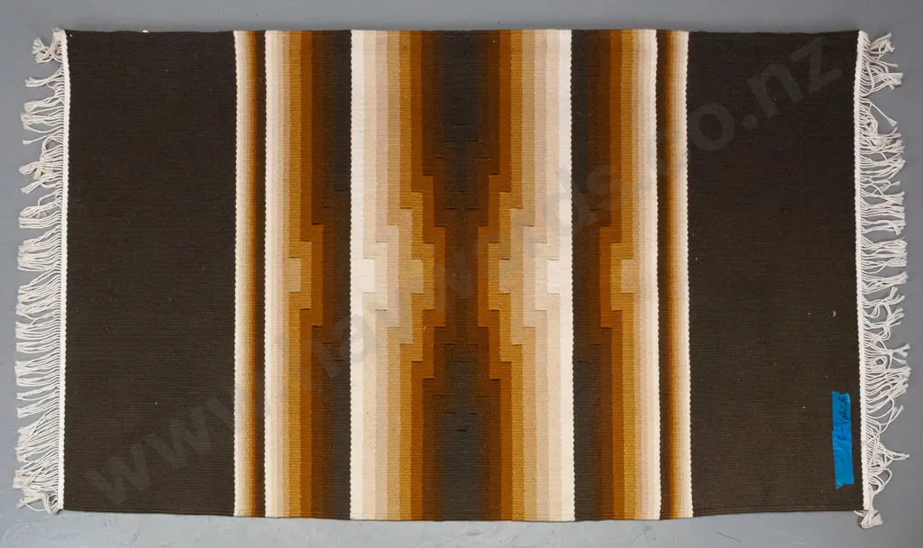 Ian Spalding, hand-woven striped kilim-style floor rug, has timber hanging bar tacked along one edge L1710 W1030 Image 1++