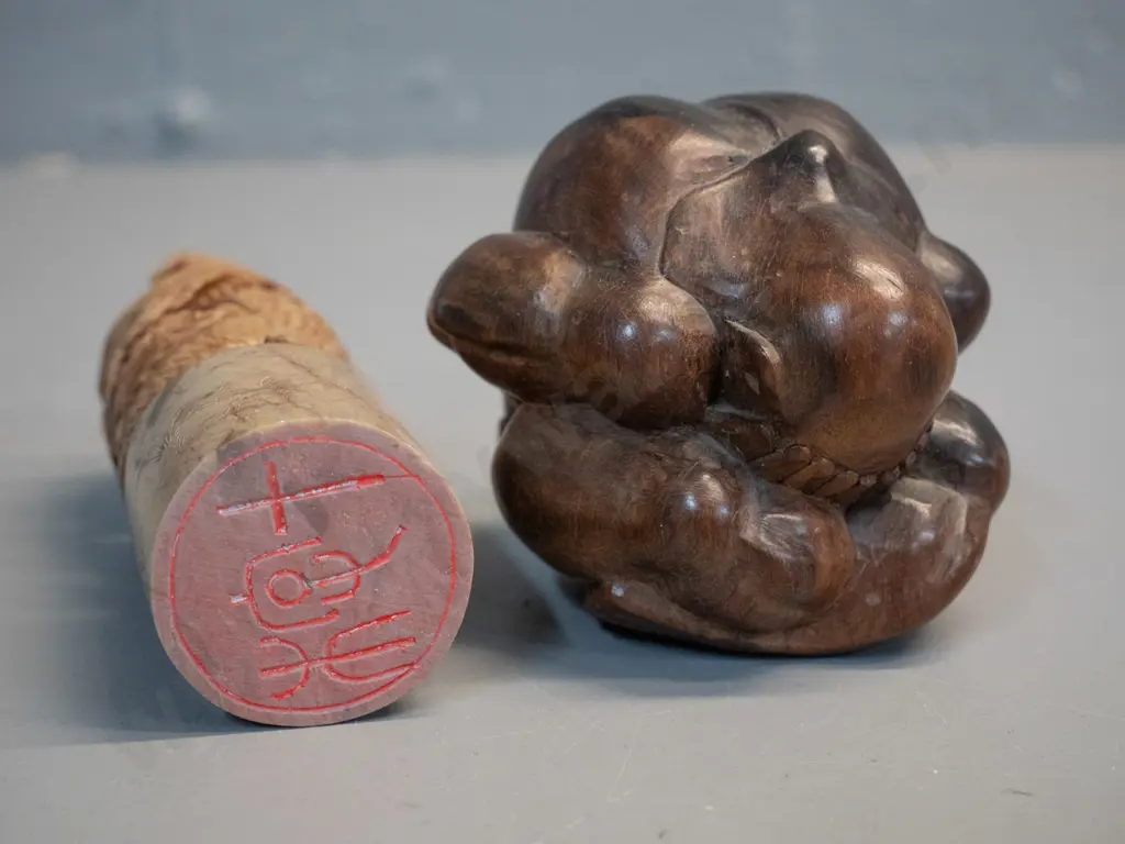 small carved timber sitting / praying figure and a Chinese carved stone dragon chop / seal H-120 Image 1++