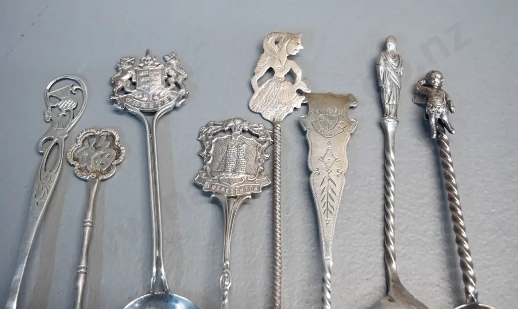16 assorted sterling silver teaspoons, some place name souvenir, some figural, some with enamel decoration Image 1++