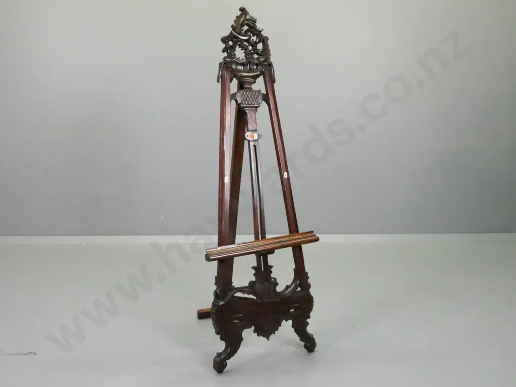 reproduction ornately carved mahogany easel / display stand with pierced crest, scrolling feet, adjustable support bar. Image 1++