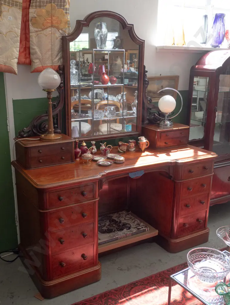 Victorian mahogany mirror-back kneehole dresser with carved foliate supports, 4 upper drawers, 8 lower, all with turned Image 1++