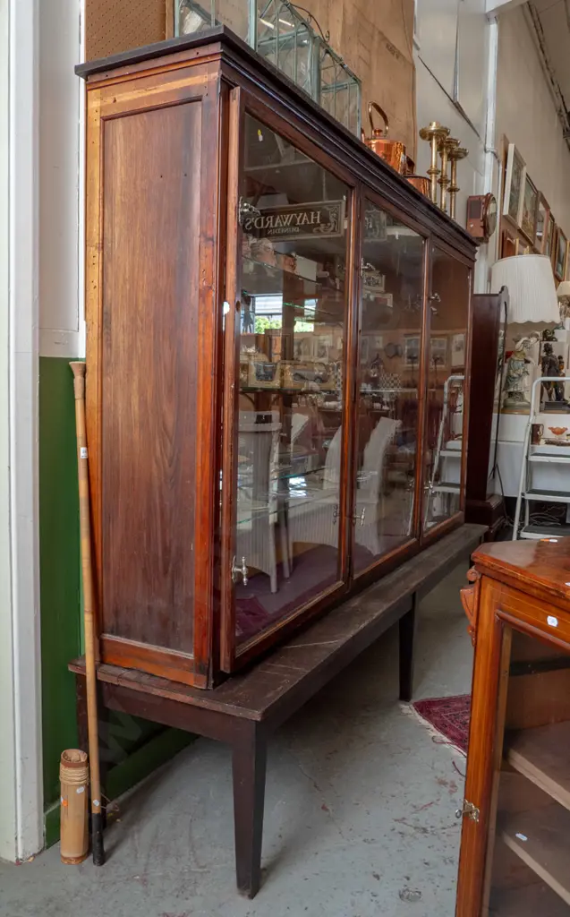 Edwardian shop display cabinet with 3 glazed doors, twist lock handles on separate table base with tapered legs Image 1++