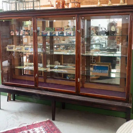 Edwardian shop display cabinet with 3 glazed doors, twist lock handles on separate table base with tapered legs