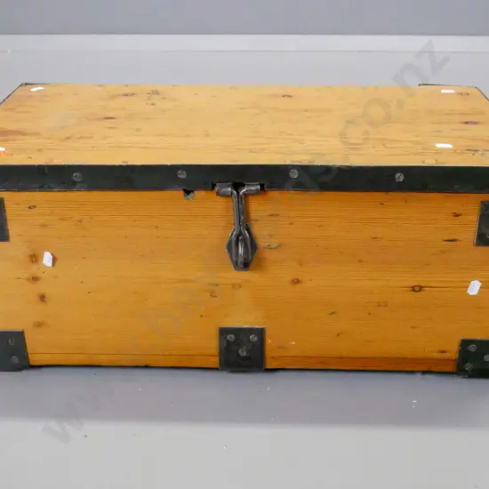 vintage small pine trunk with metal strapping, corner binding and carry handles, has non-functioning padlock. Chip to