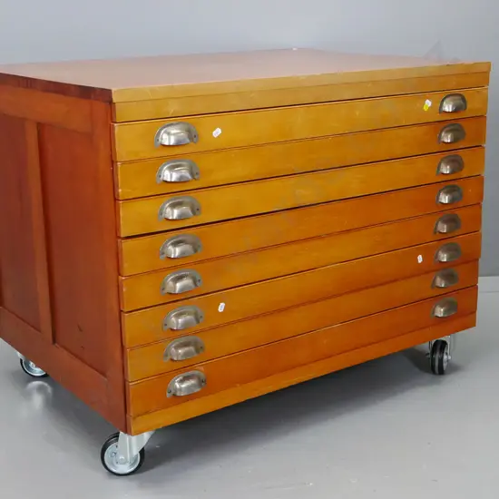 set of vintage rimu plan / map drawers - 8 drawers with hinged covers and chrome cup handles, on modern rubber casters