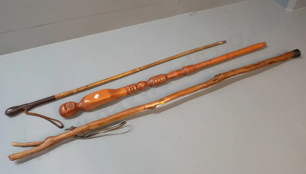 3 walking sticks - one with figural carving and inch markings, one with leather bound handle end, and one rustic walking Image 1++