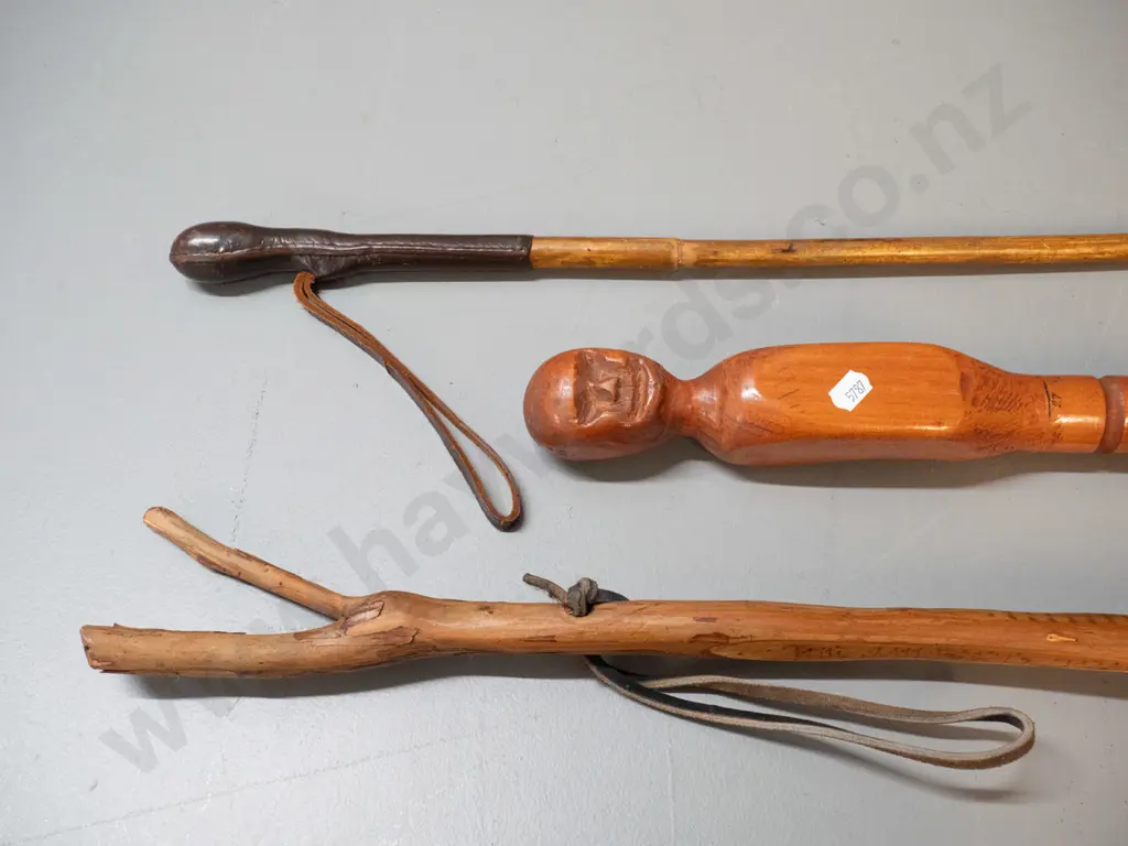 3 walking sticks - one with figural carving and inch markings, one with leather bound handle end, and one rustic walking Image 1++