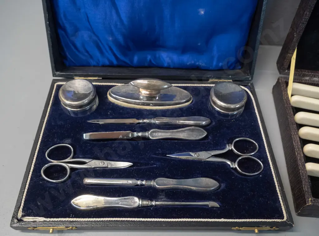 vintage cased set faux bone-handled knives and forks w/servers and a cased plated manicure set with damage to hinge Image 1++