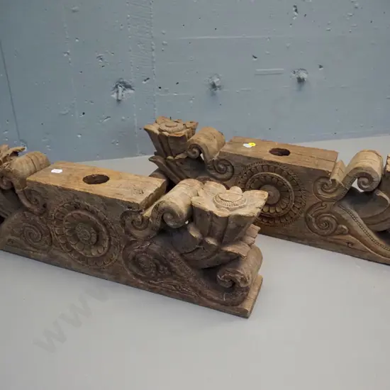 pair of hand-carved teak lintels with foliate & scrolling decoration, both large holes drilled through centre, chips to