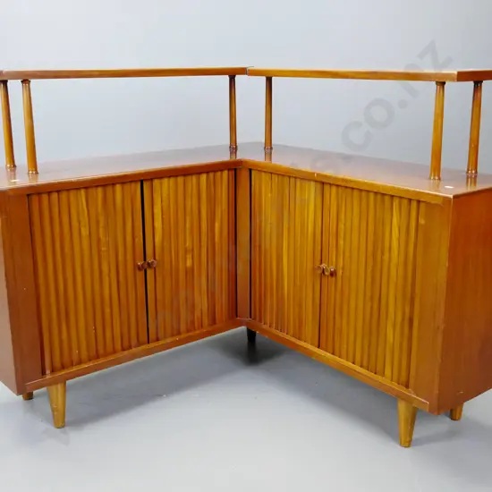 retro mahogany corner unit with top shelf on round supports, 4 sliding tambour doors - some staining to polish on top