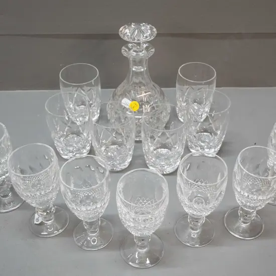 Stuart cut crystal small decanter with 6 glasses and 7 Waterford stemmed sherry or liqueur glasses. Decanter H170