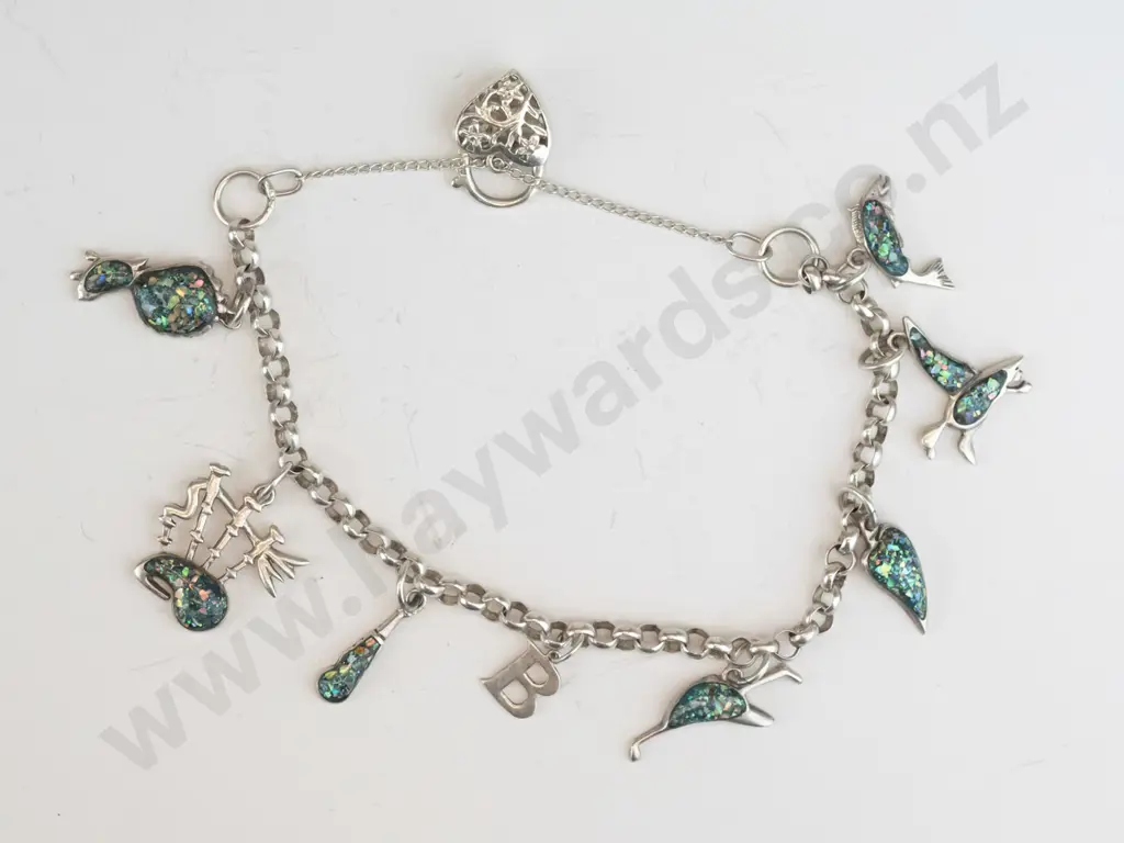 silver charm bracelet with various charms & safety chain stamped 925 Image 1++