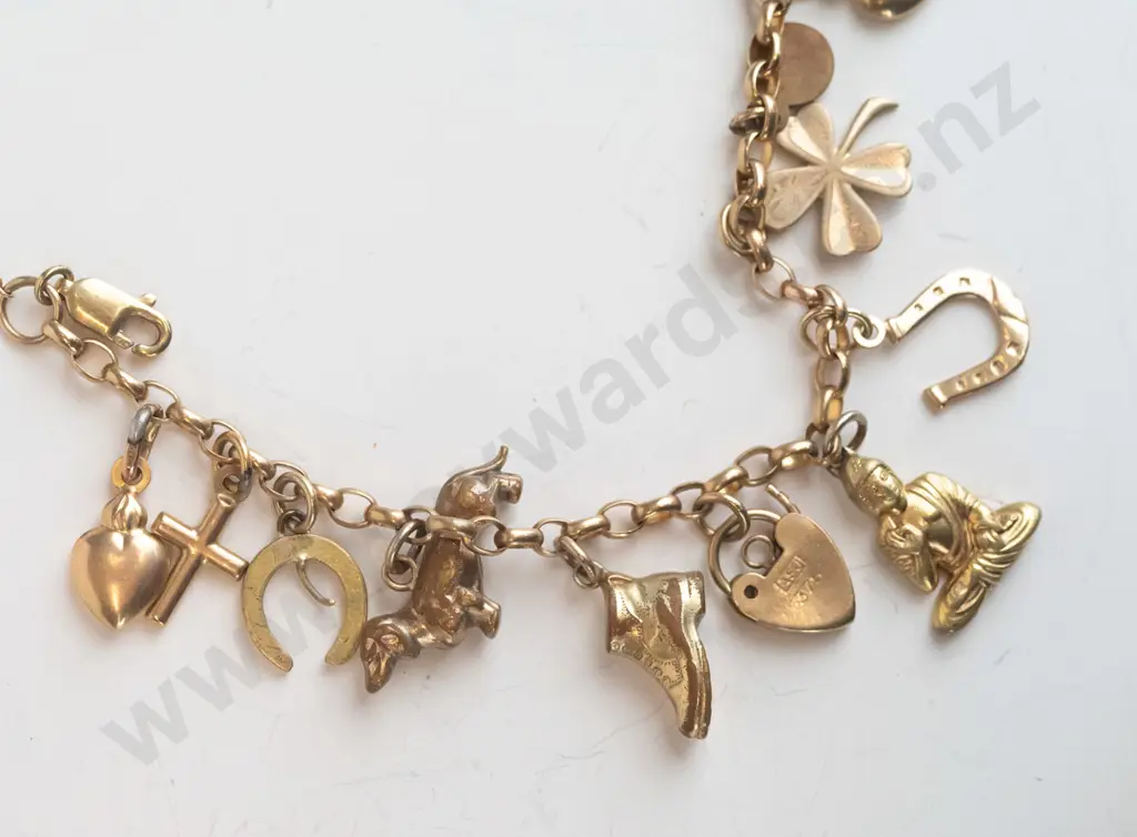 charm bracelet with various charms stamped 375 Image 1++