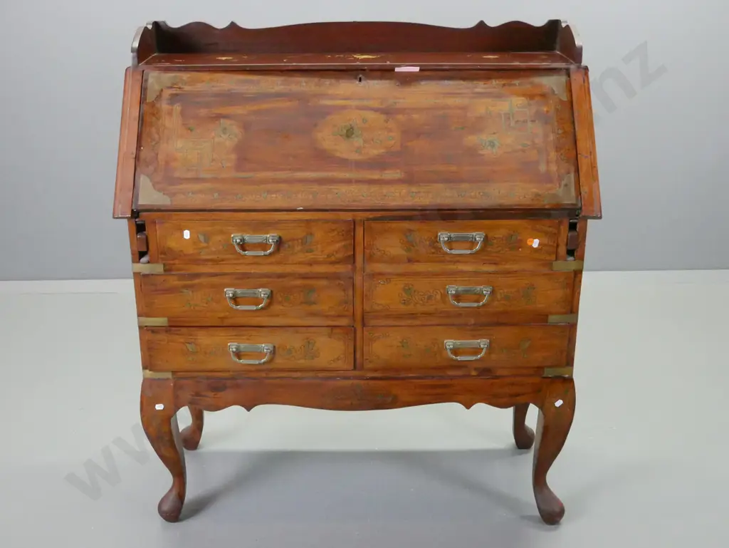 reproduction mahogany drop front desk w/ extensive brass inlay decoration, brass drop handles, 6 drawers, shaped crest Image 1++