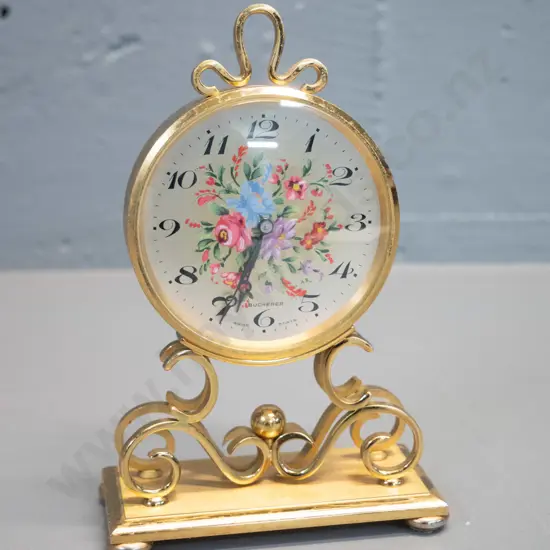 small Bucherer Swiss made brass cased clock with floral decoration on face - H-160 W-100 - some pitting or marking to