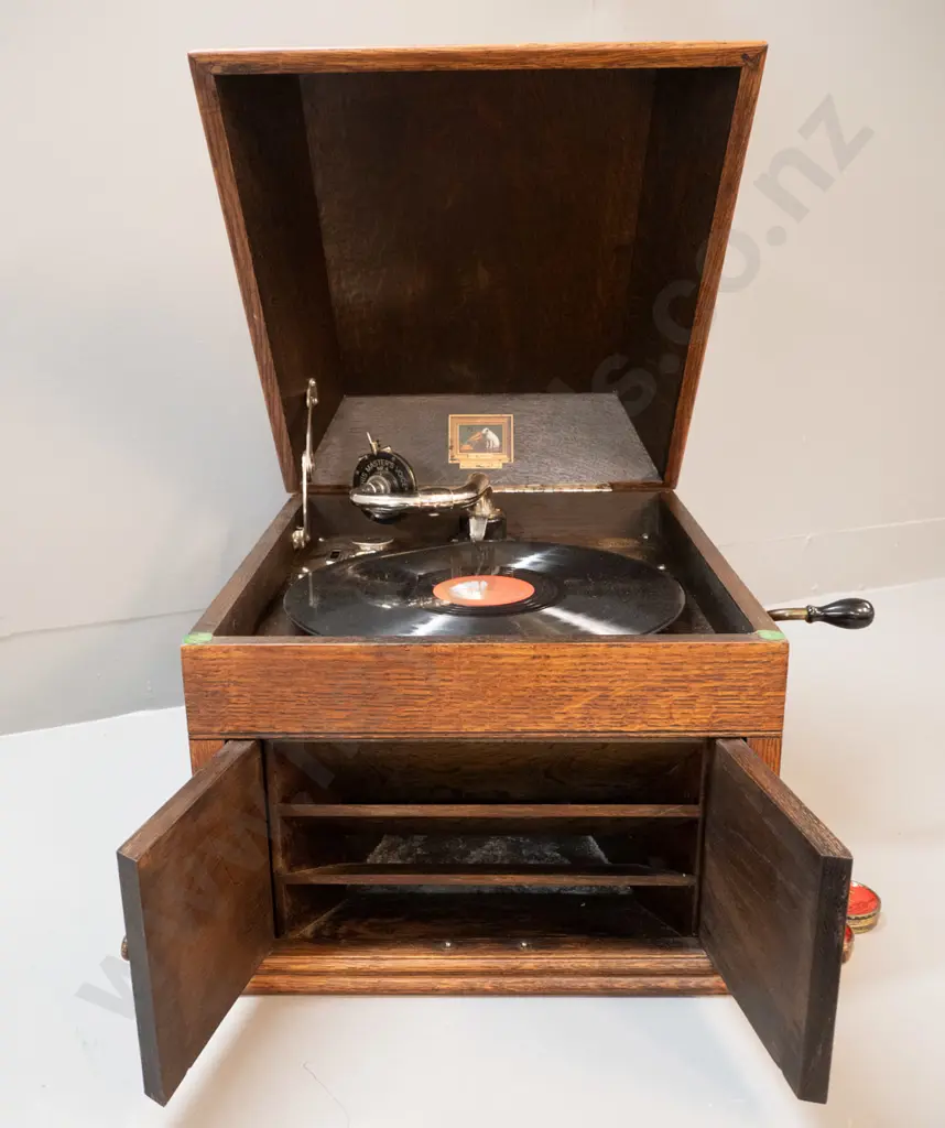 vintage oak-cased His Master's Voice "The Bristol" wind-up gramophone with one record and 3 containers of needles. Going Image 1++