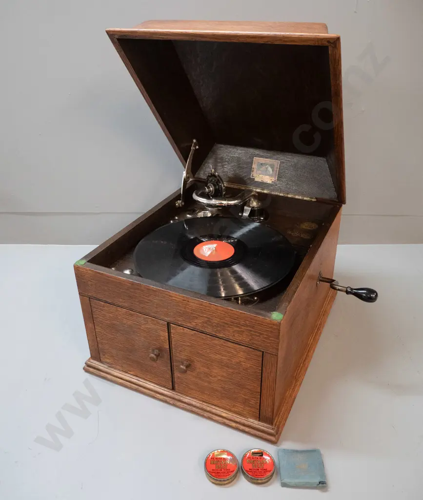 vintage oak-cased His Master's Voice "The Bristol" wind-up gramophone with one record and 3 containers of needles. Going Image 1++
